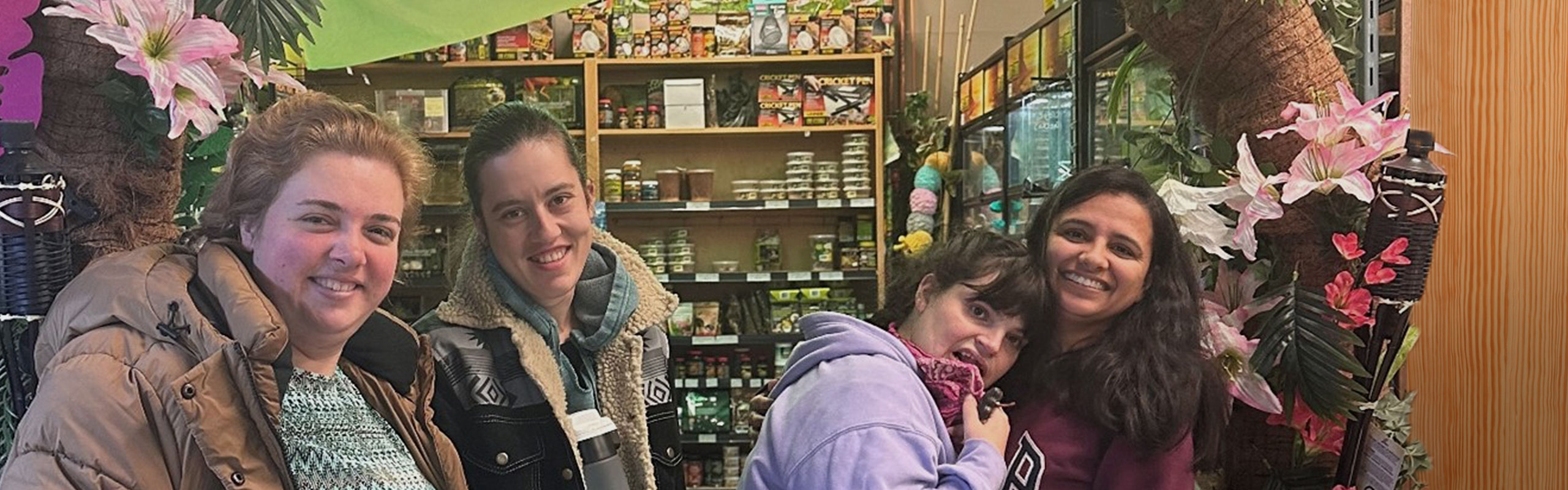 4 smiling women in pet store